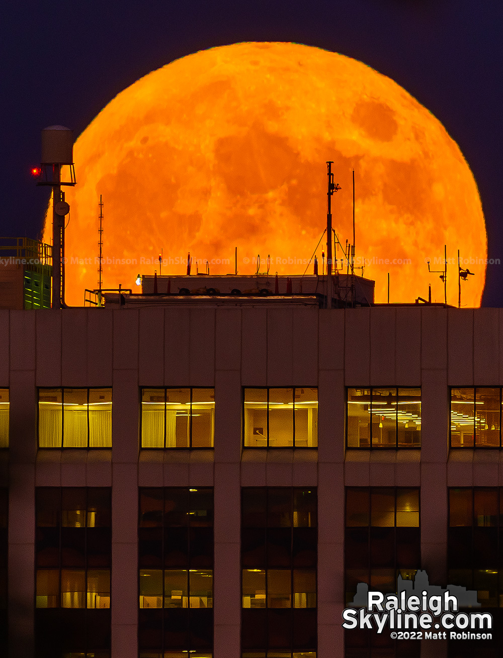 Fall orange moon rising over downtown Raleigh