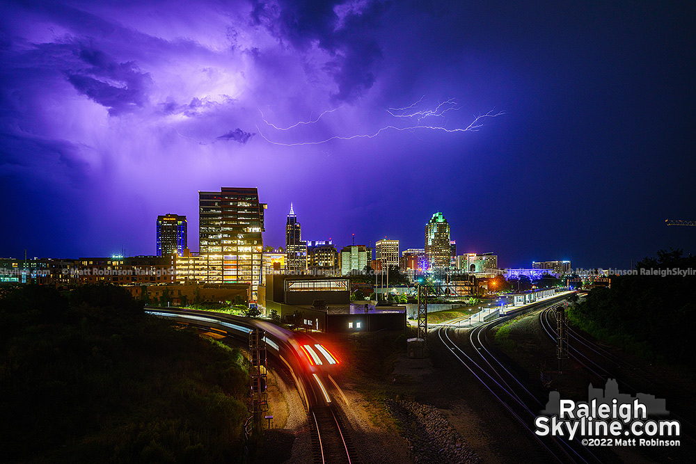 Lightning fills the sky over downtown Raleigh from the Boylan Bridge with Passing Train