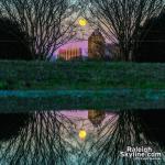 Raleigh Skyline and moon reflected in a puddle