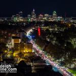 Wide view of Downtown Raleigh and the NCSU Bell Tower and Hillsborough Street lit up Red for Men's and Women's Basketball making the Elite 8