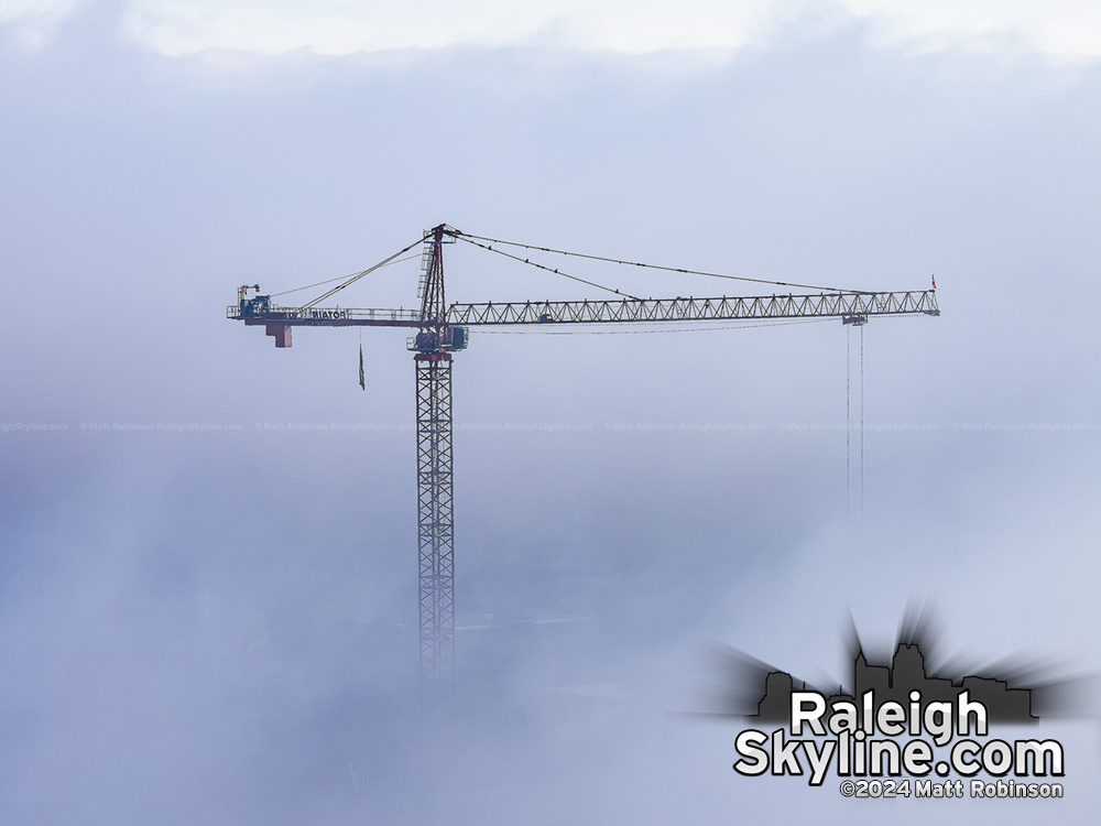 A crane for the new city hall rises out of the fog