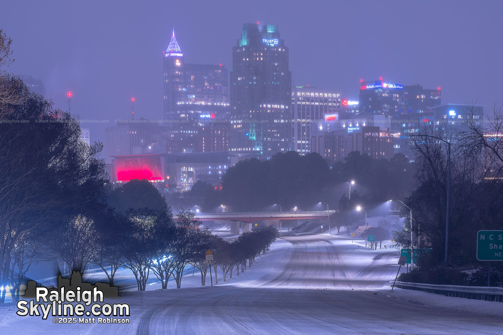 Downtown Raleigh at night with snow covered roads